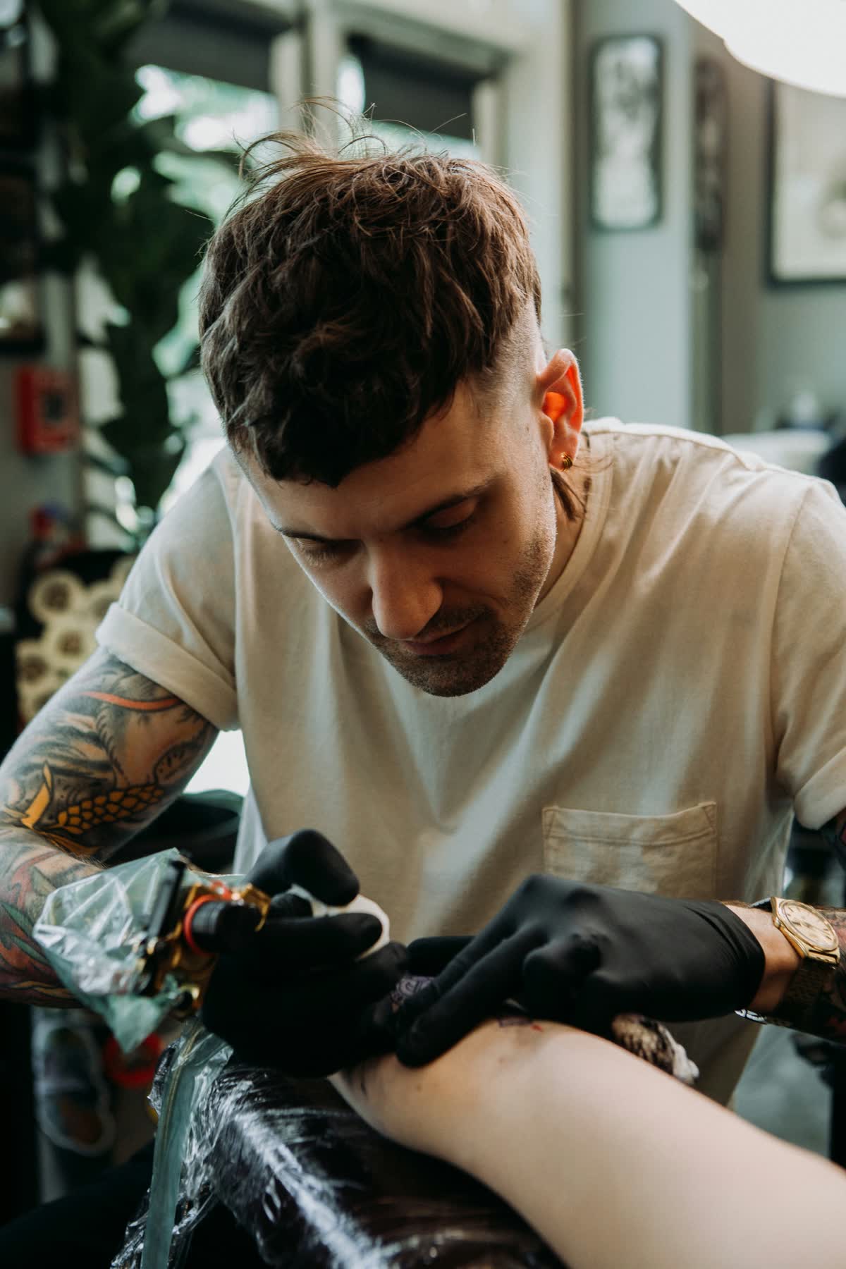 Christopher Cousins tattooing a client at Pilgrimage Tattoo